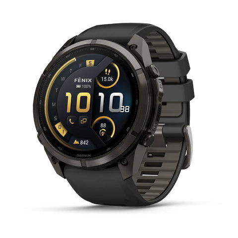A Garmin Fenix smartwatch with a round black and dark gray case and a textured black strap, shown at a three-quarter angle on a white background. The watch face displays a dark watch UI with yellow accents.