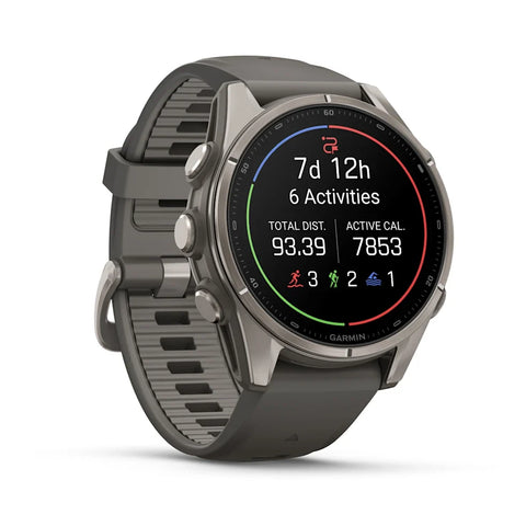 A Garmin smartwatch with a dark gray textured silicone strap and a silver-toned metallic case, shown at a three-quarter angle on a clean white background.