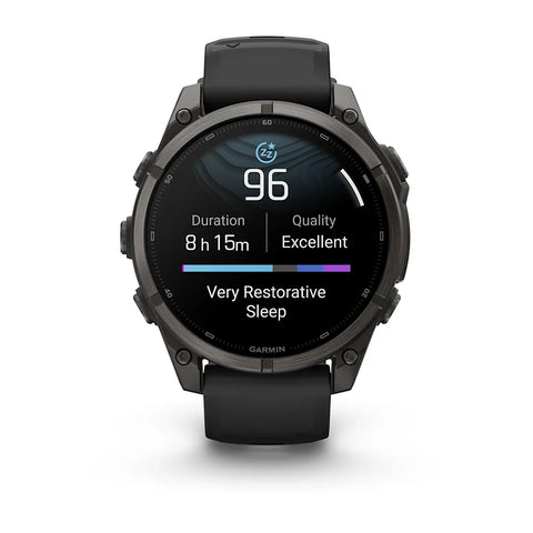 A Garmin smartwatch with a black round case and black strap, shown against a plain white background. The watch face displays a sleep and activity tracking interface.