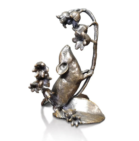 Bronze sculpture of a mouse climbing a branch with flowers on a white background