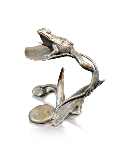 Bronze sculpture of a frog on a leaf with a white background