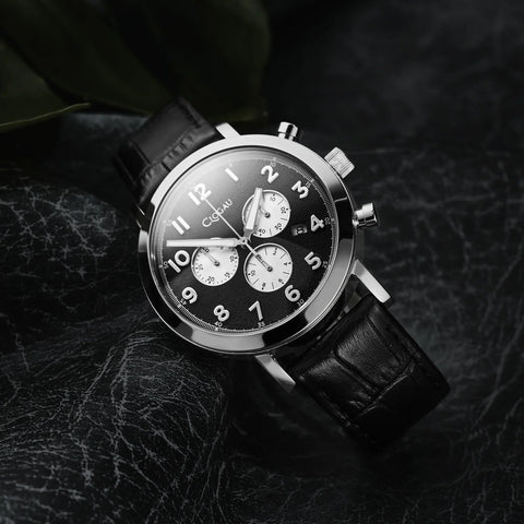 Black wristwatch with a detailed face on a dark textured background