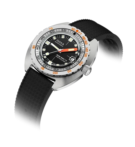A Doxa Swimmer watch with a silver stainless steel case, black dial, black textured silicone strap, and orange accents on the bezel and hands, shown on a white background with a soft shadow.