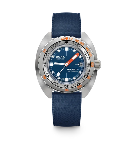 A DOXA Sub Diver 700 wristwatch with a blue textured strap, a silver stainless steel case, a blue dial with white and orange details, and a rotating bezel, shown against a plain white background.