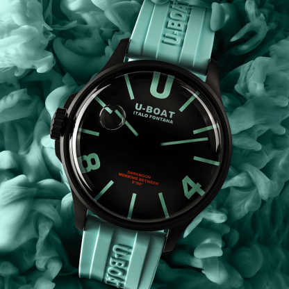 U-Boat watch with green strap on a textured green background