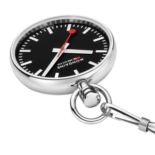 A Mondaine watch keychain with a round silver stainless steel case, a black dial with white hands and markers, and a red second hand, attached to a silver metal ring and clip on a white background.