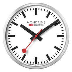 A round wall clock with a silver-toned metal frame, a white dial, black hour markers and hands, and a red second hand with a red bobble. The brand name 'MONDAINE' is printed on the dial, along with 'SBB CFF FFS' and 'OFFICIAL SWISS RAILWAYS CLOCK DESIGN'.
