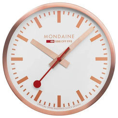 A round wall clock with a rose gold metallic frame, a white dial, rose gold hour markers and hands, and a red second hand. The brand name 'MONDAINE' is printed on the dial, along with 'SBB CFF CFFS'.