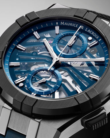 Maurice Lacroix watch with blue face and black case on gray background