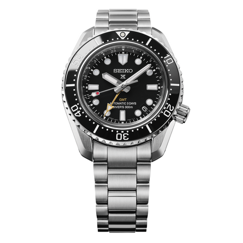 Seiko watch with black dial and silver metal bracelet on a white background
