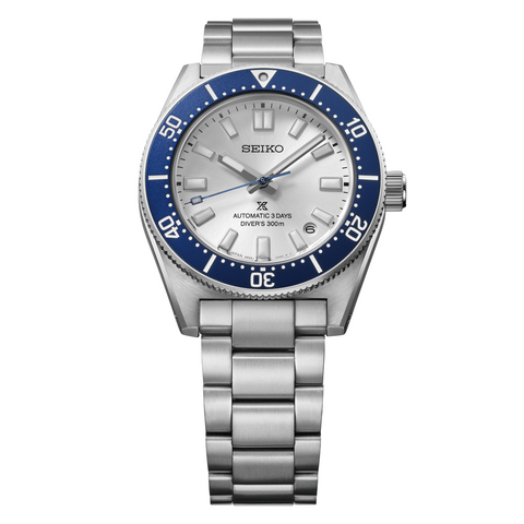 Seiko watch with silver bracelet and blue bezel on a white background