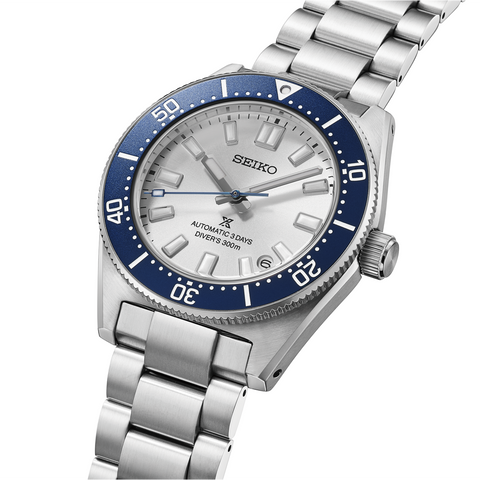 Seiko watch with silver bracelet and blue bezel on a white background