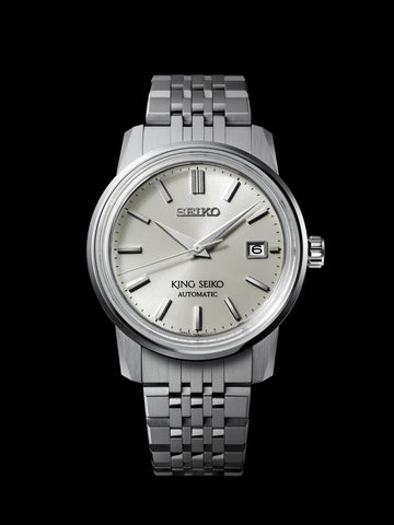 Silver Seiko watch with a metallic band on a black background