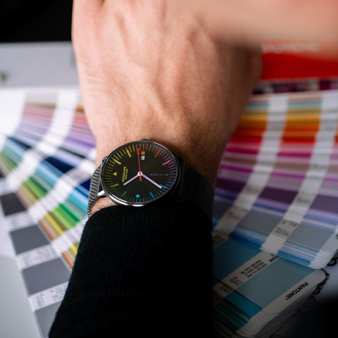 Person wearing a colorful watch with color swatches in the background
