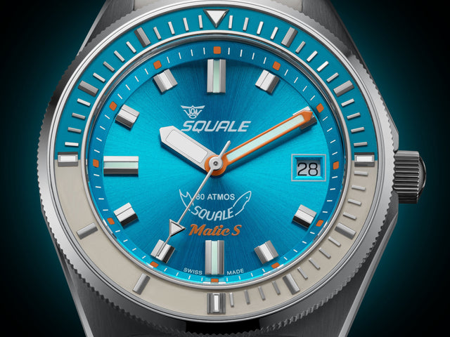 Squale watch with blue dial and silver case on a dark background