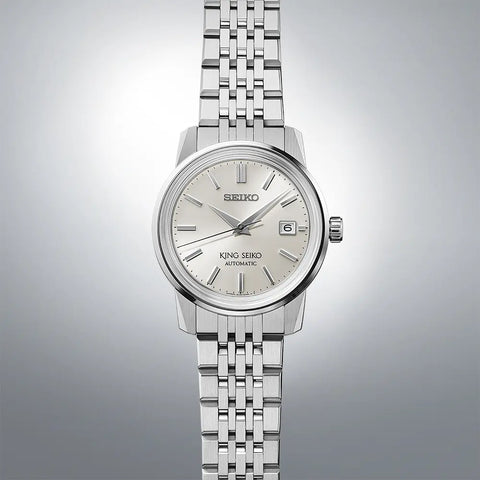 Silver Seiko watch on a gradient gray background