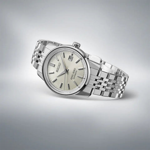 Silver Seiko watch on a gray background