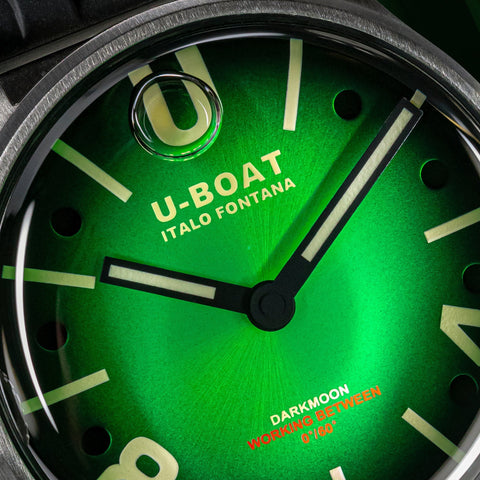 Close-up of a U-Boat watch face with green dial and visible brand name.