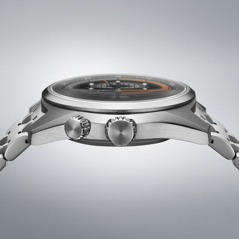 Close-up of a silver watch with detailed design on a gray background