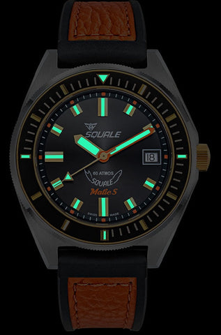 Watch with black face and brown leather strap on a black background