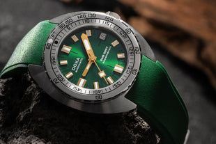 Doxa Sub 200T watch featuring a sleek design with a Green dial, luminous markers, and a rotating bezel.