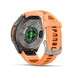 Fenix 9 GTS smartwatch shown from the back, featuring a metallic gray case and a bright orange silicone strap with a silver buckle, on a white background.
