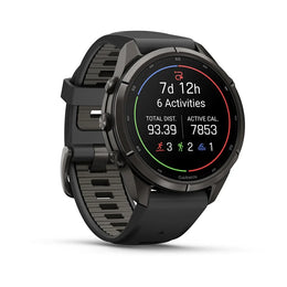 A Garmin smartwatch with a black round case and a textured black strap, shown at a three-quarter angle on a clean white background. The digital display is active, showing fitness metrics.