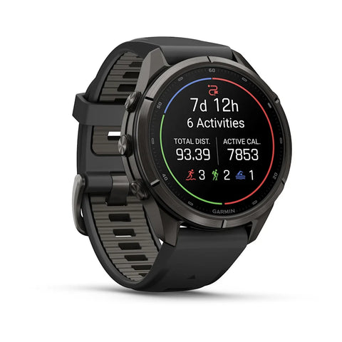 A Garmin smartwatch with a black round case and a textured black strap, shown at a three-quarter angle on a clean white background. The digital display is active, showing fitness metrics.