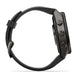 A black smartwatch with a rugged protective case and a matching black silicone strap, shown from a side profile view on a white background.