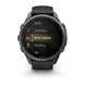 A Garmin smartwatch with a dark gray metallic case and a black strap, shown on a clean white background. The watch screen displays fitness activity options including MTB, Trail Run, Row Indoor, Rucking, and Ski.