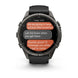 A Garmin smartwatch with a dark gray metallic case and black strap, shown on a clean white background. The watch screen displays a messaging app interface with orange and gray text bubbles.