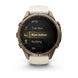 A Garmin smartwatch with a round bronze-toned case and a light beige strap, shown on a clean white background. The watch face displays a fitness menu with options like MTB, Trail Run, Row Indoor, Rucking, and Ski.