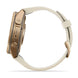 A smartwatch shown from the side with a cream-colored leather strap and a metallic rose gold case. The brand name 'FENIX' is clearly visible on the side of the watch.