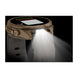 A rugged smartwatch with a tan and black face and a white strap, shown with a bright front light turned on and casting a beam of light downward. The watch has 'PENIK' branding on the side.