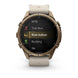 A Garmin smartwatch with a bronze-toned metal case and a light beige leather strap, shown on a clean white background. The watch face displays a fitness menu with options like MTB, Trail Run, Row Indoor, Rucking, and Ski.