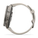 A close-up side view of a smartwatch with a metallic gray case and a light beige or off-white strap, featuring the brand name 'FENIX' on the side of the case, set against a plain white background.