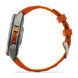 A rugged smartwatch with a metallic silver-gray case and a vibrant orange textured strap, shown from a side profile view on a clean white background.