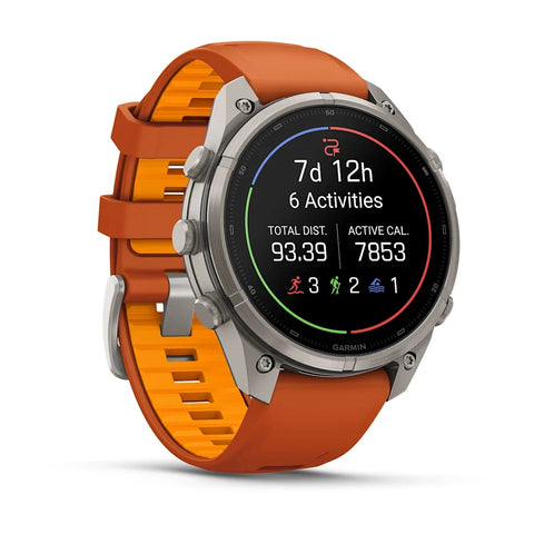 A Garmin smartwatch with a round silver stainless steel case and an orange and orange-yellow silicone strap, shown on a clean white background with a soft shadow.