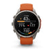 A Garmin smartwatch with a silver-toned metal case and an orange leather strap, shown on a clean white background. The watch face is active with various fitness and health metrics displayed.