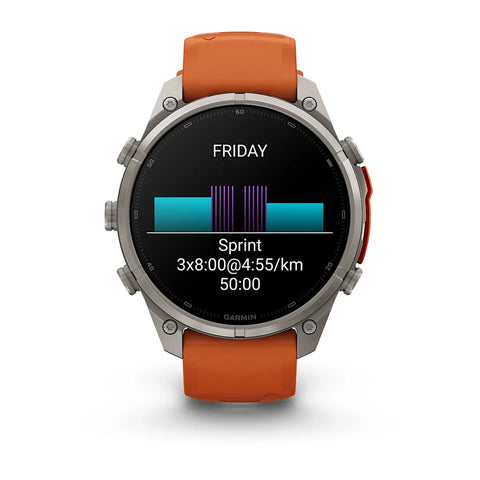 A Garmin smartwatch with a silver-toned metal case and an orange strap, shown against a plain white background. The watch face is on and displaying a fitness screen with the word 'FRIDAY' and a sprint workout summary.