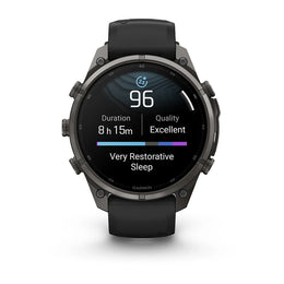 A Garmin smartwatch with a black strap and dark metallic case, shown from the front on a clean white background. The watch face displays sleep and activity metrics.
