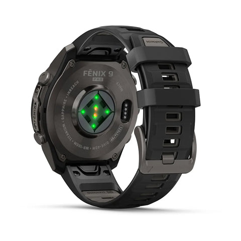 A black Fénix 9 Pro smartwatch shown from the back, featuring a matte black titanium case, a textured black silicone strap, and a circular backplate with a green and yellow illuminated heart sensor.
