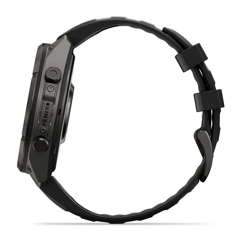A black rugged smartwatch shown from the side profile against a clean white background, featuring a textured black strap and a dark metallic case with visible button controls and the brand name 'FENIX'.
