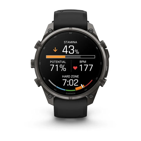 A Garmin smartwatch with a black strap and dark gray metallic case, displaying a fitness watch face with Polish text on a clean white background.
