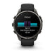 A Garmin smartwatch with a black strap and dark metallic case, shown from the front on a white background. The watch screen displays a fitness summary for 'FRIDAY' with a sprint workout record.