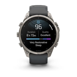 A Garmin smartwatch with a dark gray silicone strap and a silver-toned metal case, shown on a clean white background. The watch face is active with a sleep tracking display.