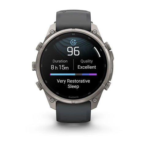 A Garmin smartwatch with a dark gray silicone strap and a silver-toned metal case, shown on a clean white background. The watch face is active with a sleep tracking display.
