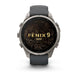 A Garmin Fenix 9 Pro smartwatch with a round silver-toned metal case, dark gray silicone strap, and a black display showing a gold topographic map design with the text 'FENIX 9 PRO'.