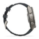 A side profile view of a rugged smartwatch with a dark gray textured silicone strap and a metallic gray case, featuring three side buttons, set against a plain white background.