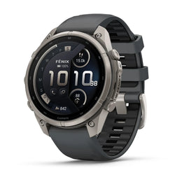 A Garmin smartwatch with a dark gray silicone strap and a silver-toned titanium case, shown at a three-quarter angle on a white background.